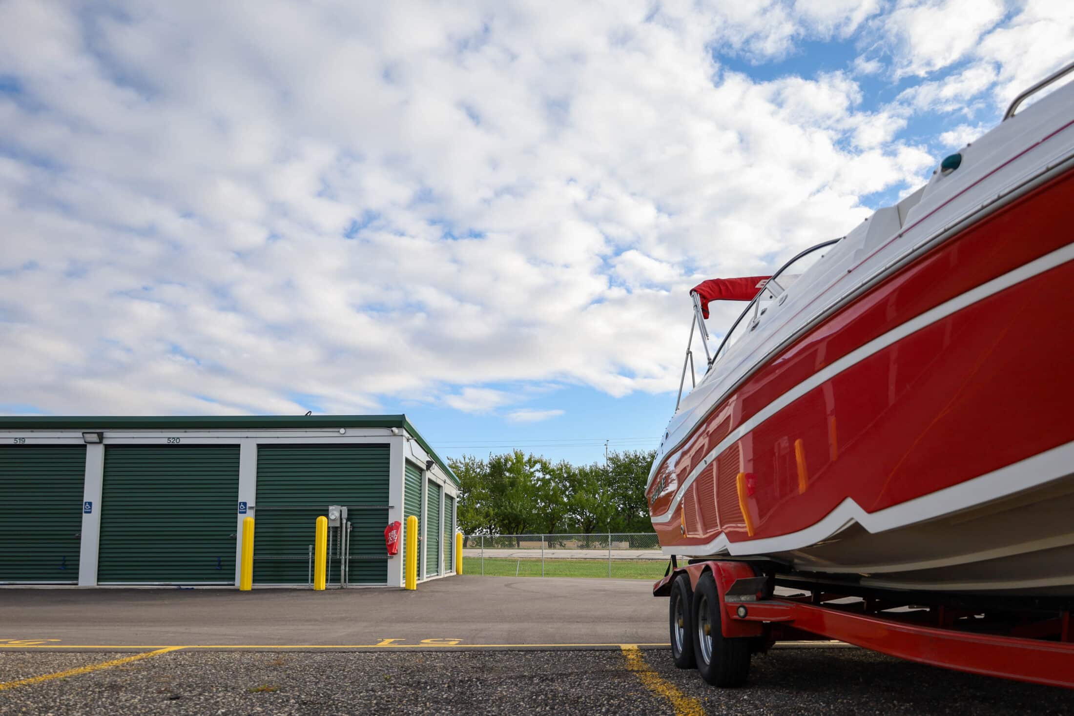 Drive-up storage units in Belvidere. Parking lot in the facility to store boats, campers, RVs, semi trucks & other large vehicles as well. Boxed Up Self-storage is your go to storage facility in Belvidere. Low angle photo of red sports boat.
