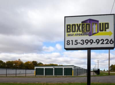 Boxed Up Self-Storage in Poplar Grove on IL-173. Drive up storage units near Poplar Grove. Main entrance with signage and partially cloudy skies.